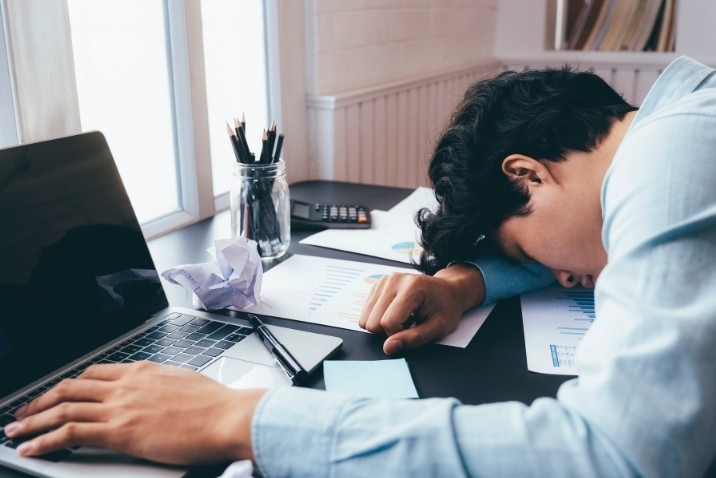 man experiencing fatigue at work
