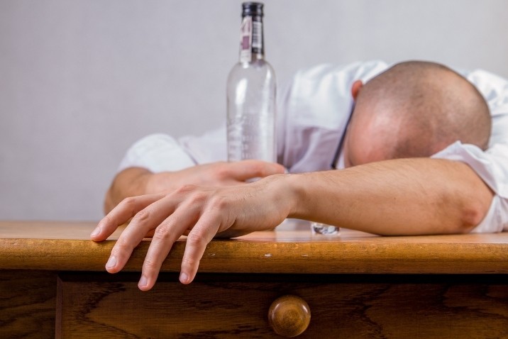 man having hangover after bad reaction from alcohol and cbd