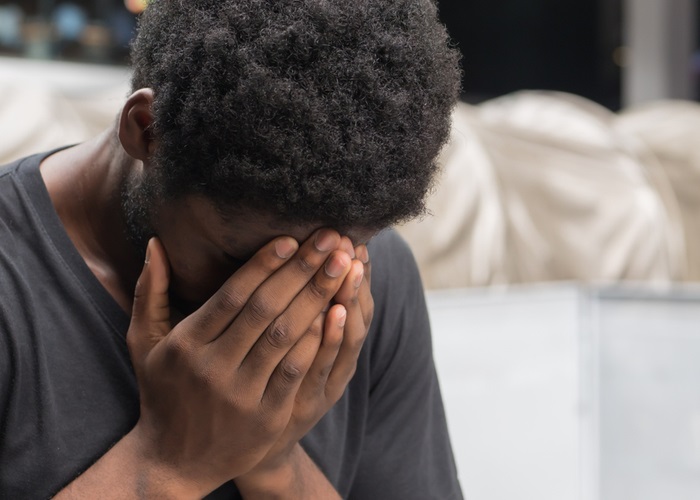 man experiencing anxiety doing face palm gesture