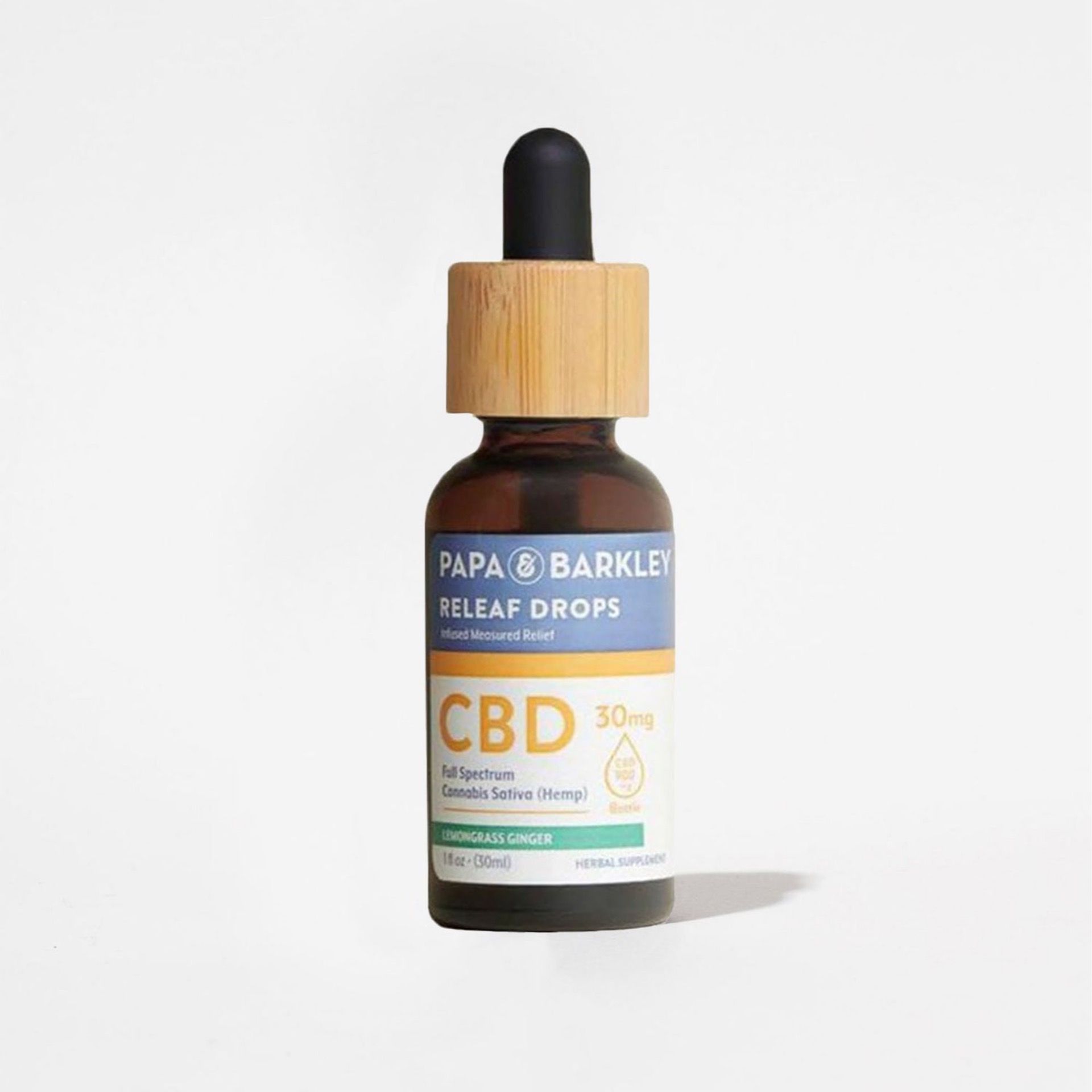 A brown glass bottle with a wooden dropper cap labeled 'Papa & Barkley Releaf Drops CBD 30mg Full Spectrum Cannabis Sativa (Hemp) Lemongrass Ginger'