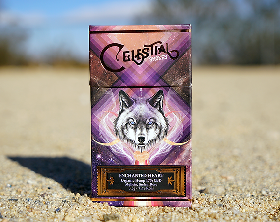 Box of Celestial Smokes Enchanted Heart organic hemp CBD pre-rolls featuring a wolf illustration.