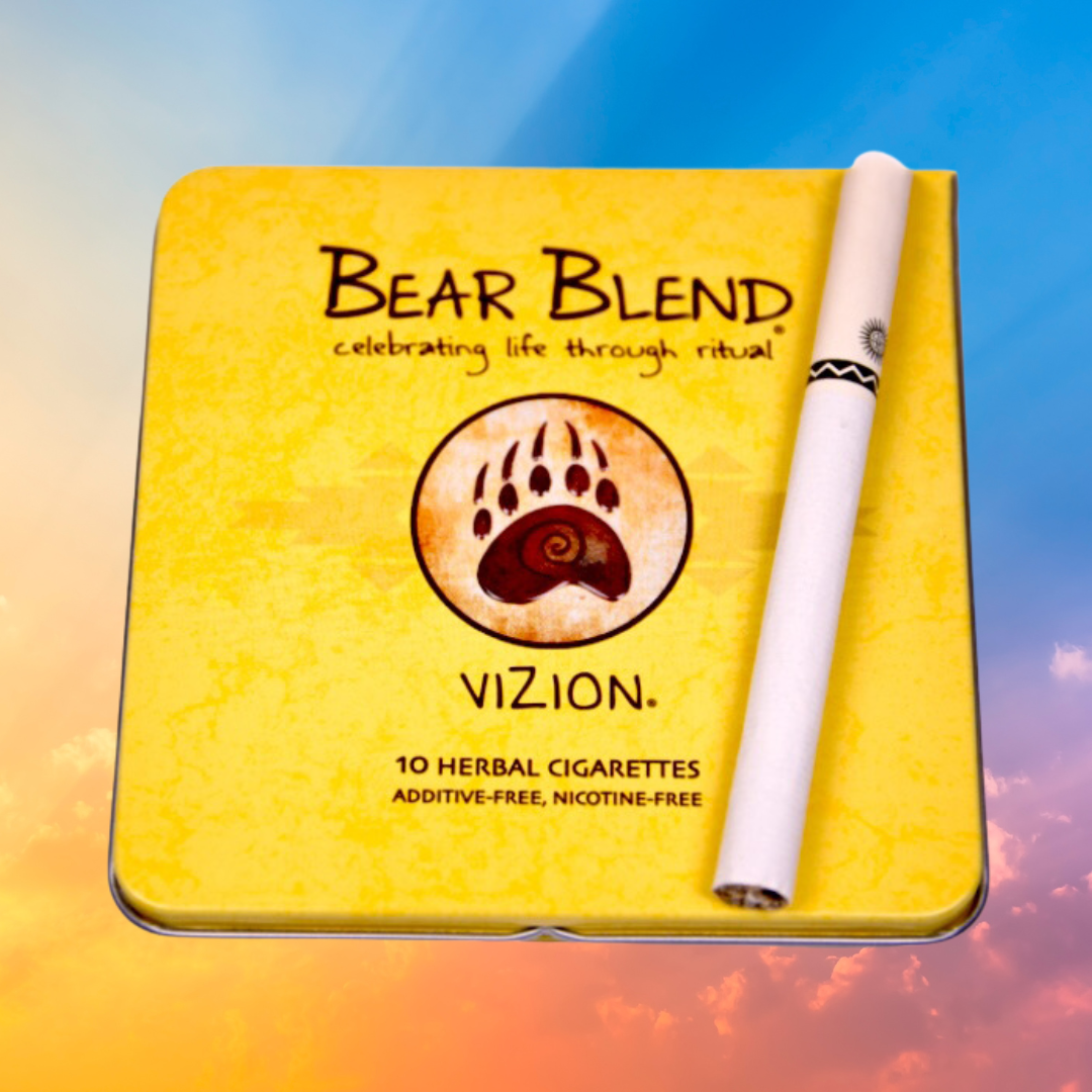 Yellow Bear Blend Vizion herbal cigarettes tin with one cigarette resting on top against a gradient sky background